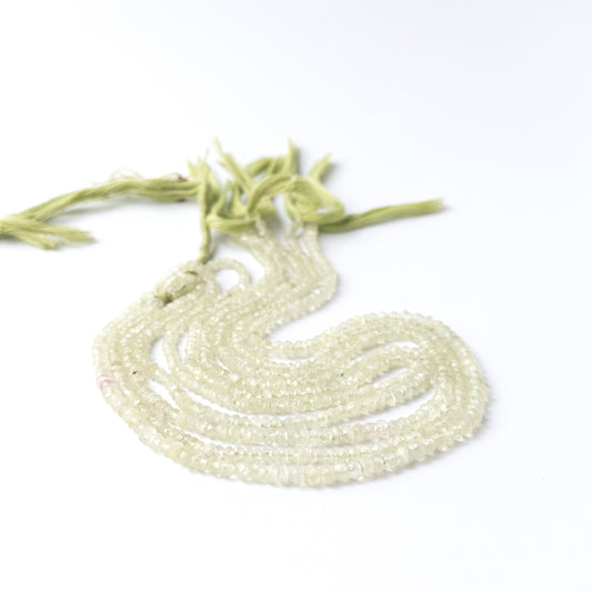 Genuine Prehnite gemstone beads arranged on a 33cm strand, showcasing clarity and subtle sparkle.
