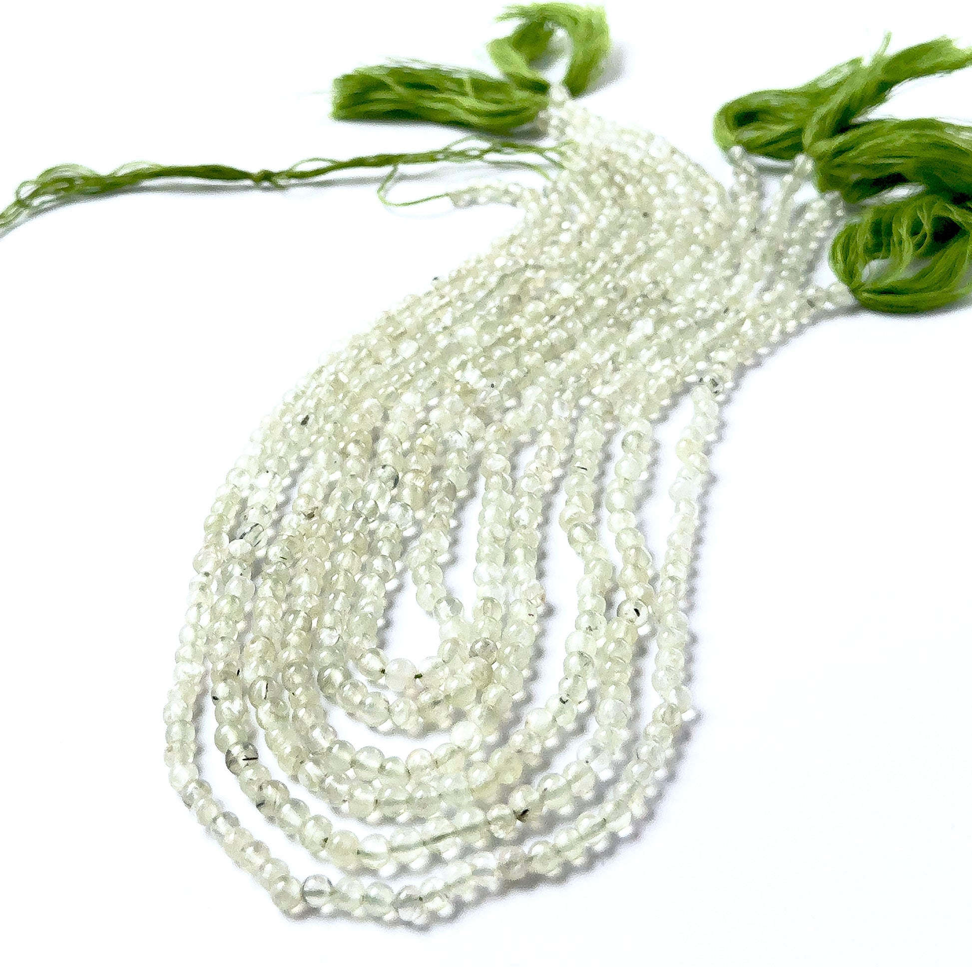 Prehnite smooth round gemstones with even spherical shaping and gentle apple‑green colour across a 34cm strand.