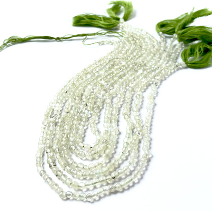 Prehnite smooth round gemstones with even spherical shaping and gentle apple‑green colour across a 34cm strand.
