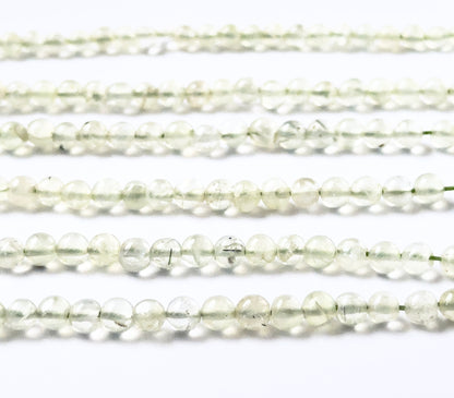 Prehnite gemstones in smooth round form, offering a clean glossy finish and calming pale‑green tones.