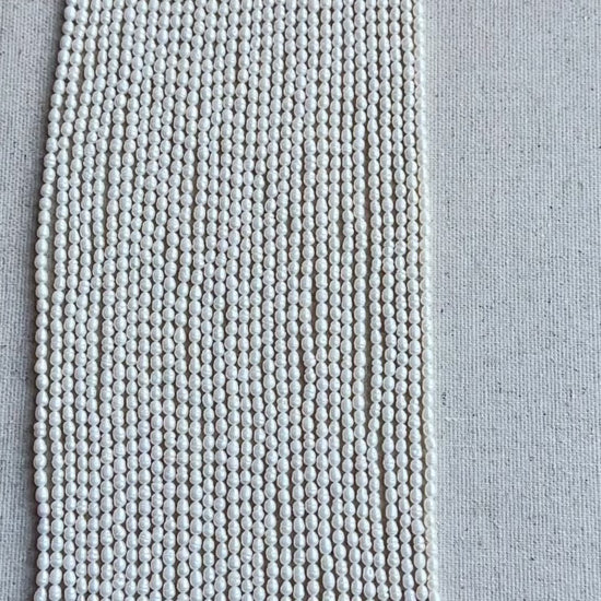 Baroque Rice Pearls showing irregular shapes and high-quality glow displayed on cream backdrop.
