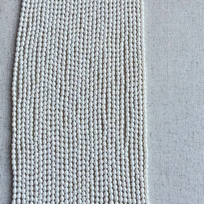 Baroque Rice Pearls showing irregular shapes and high-quality glow displayed on cream backdrop.