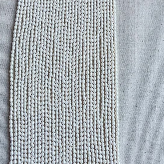 Baroque Rice Pearls showing irregular shapes and high-quality glow displayed on cream backdrop.