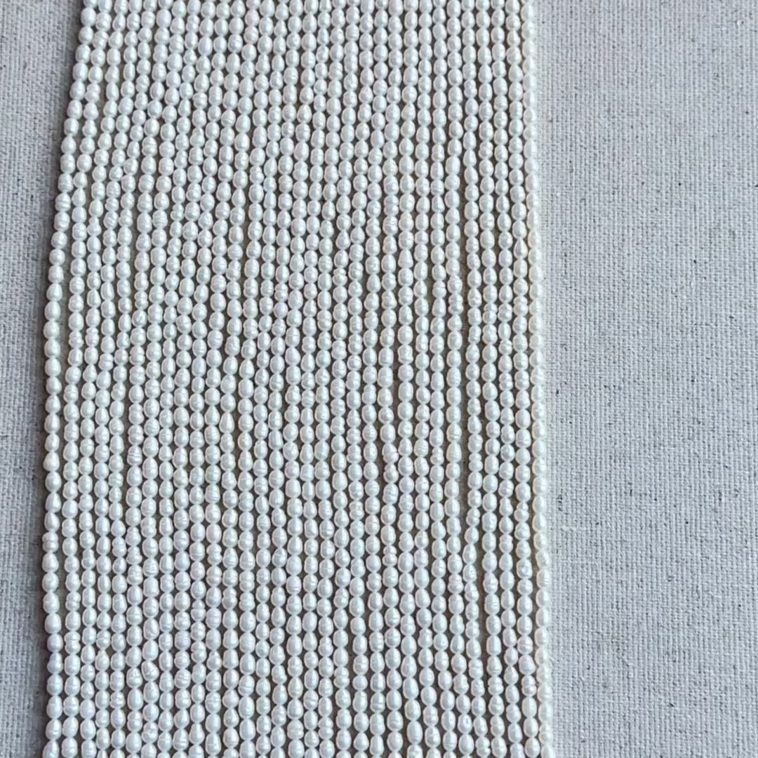 Baroque Rice Pearls showing irregular shapes and high-quality glow displayed on cream backdrop.