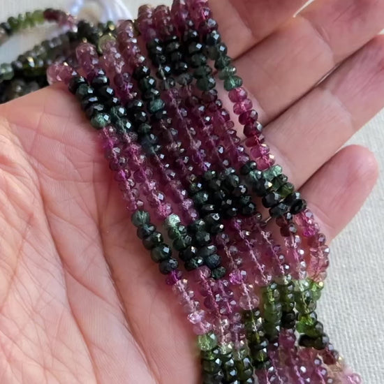 Sparkling tourmaline gemstones shaped in rondelle cuts with shimmering surfaces and clear detailing.