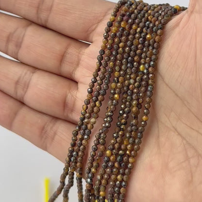 Tiger Eye 2.2 or 2.5mm micro faceted rondelles arranged in a row to showcase their uniform cut and shine.