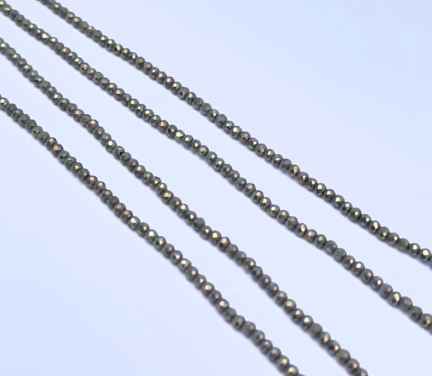 Pyrite gemstone beads for DIY jewellery displayed with soft lighting and texture.