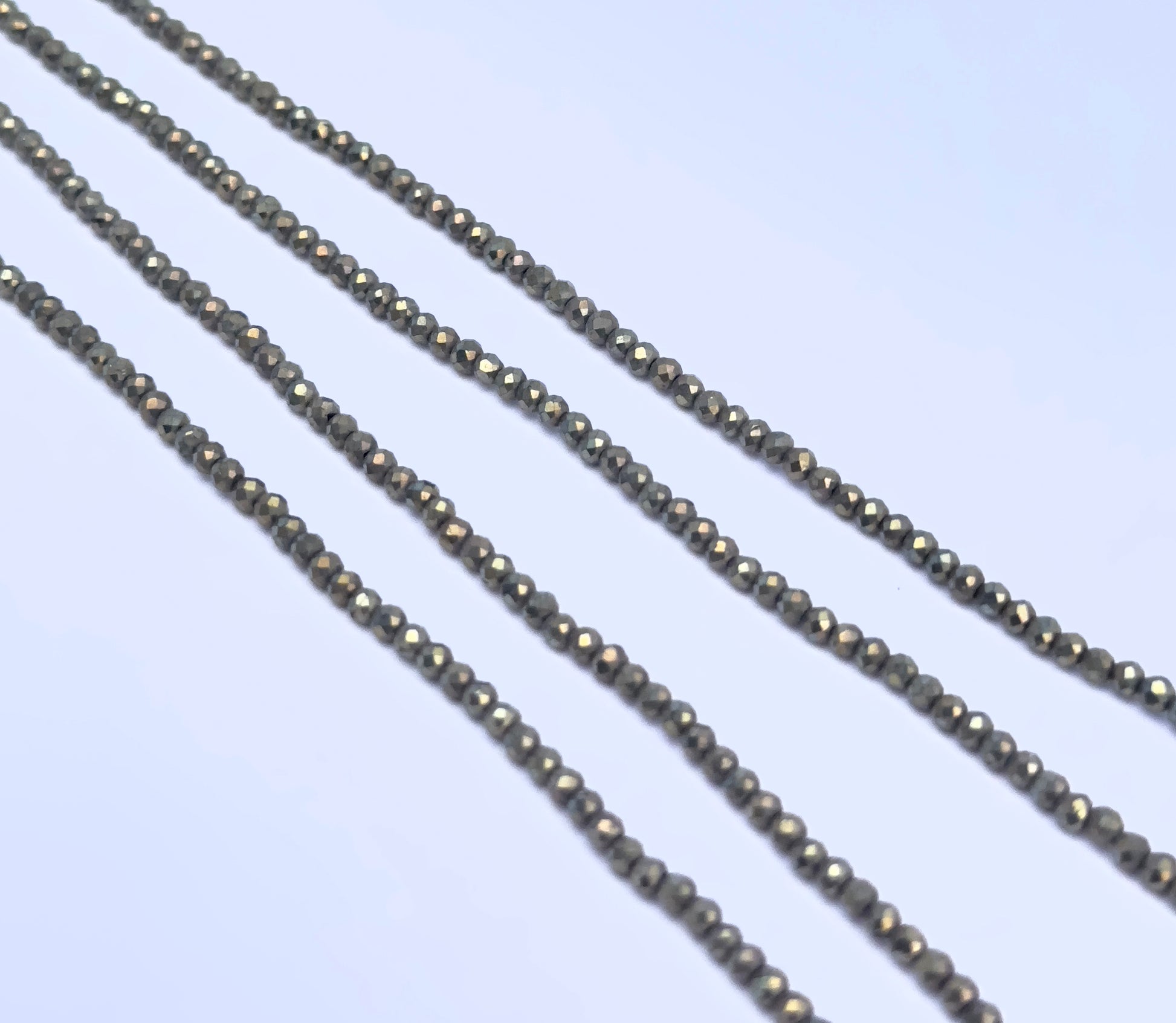 Pyrite gemstone beads for DIY jewellery displayed with soft lighting and texture.