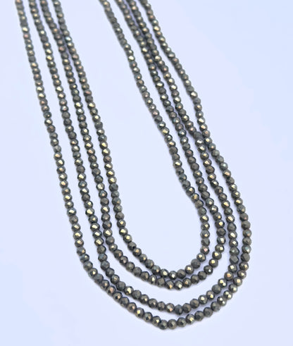 Natural Pyrite stone beads arranged in parallel strands with subtle shimmer.