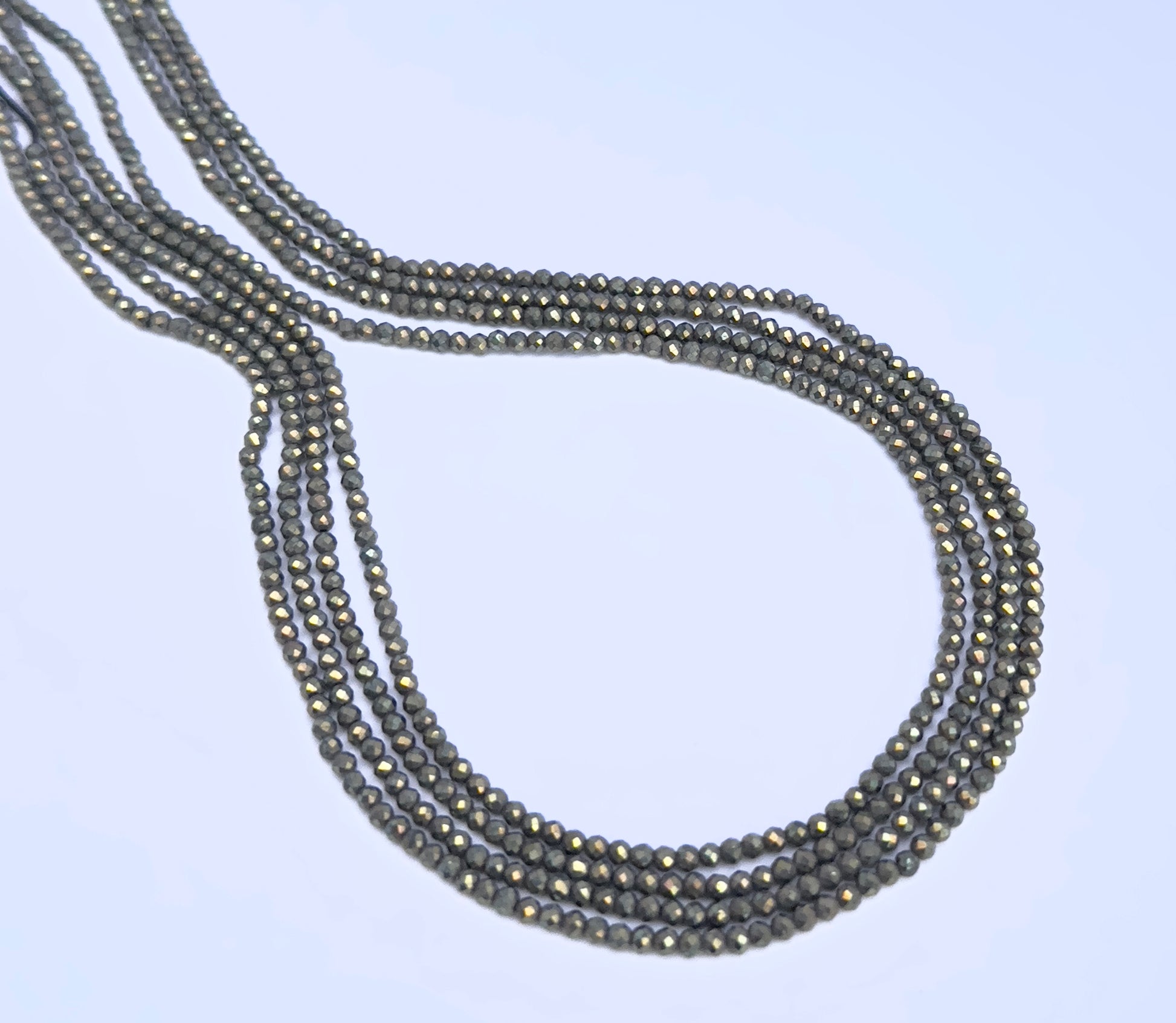 Pyrite faceted rondelle beads in gunmetal grey tones strung in a 33cm strand.