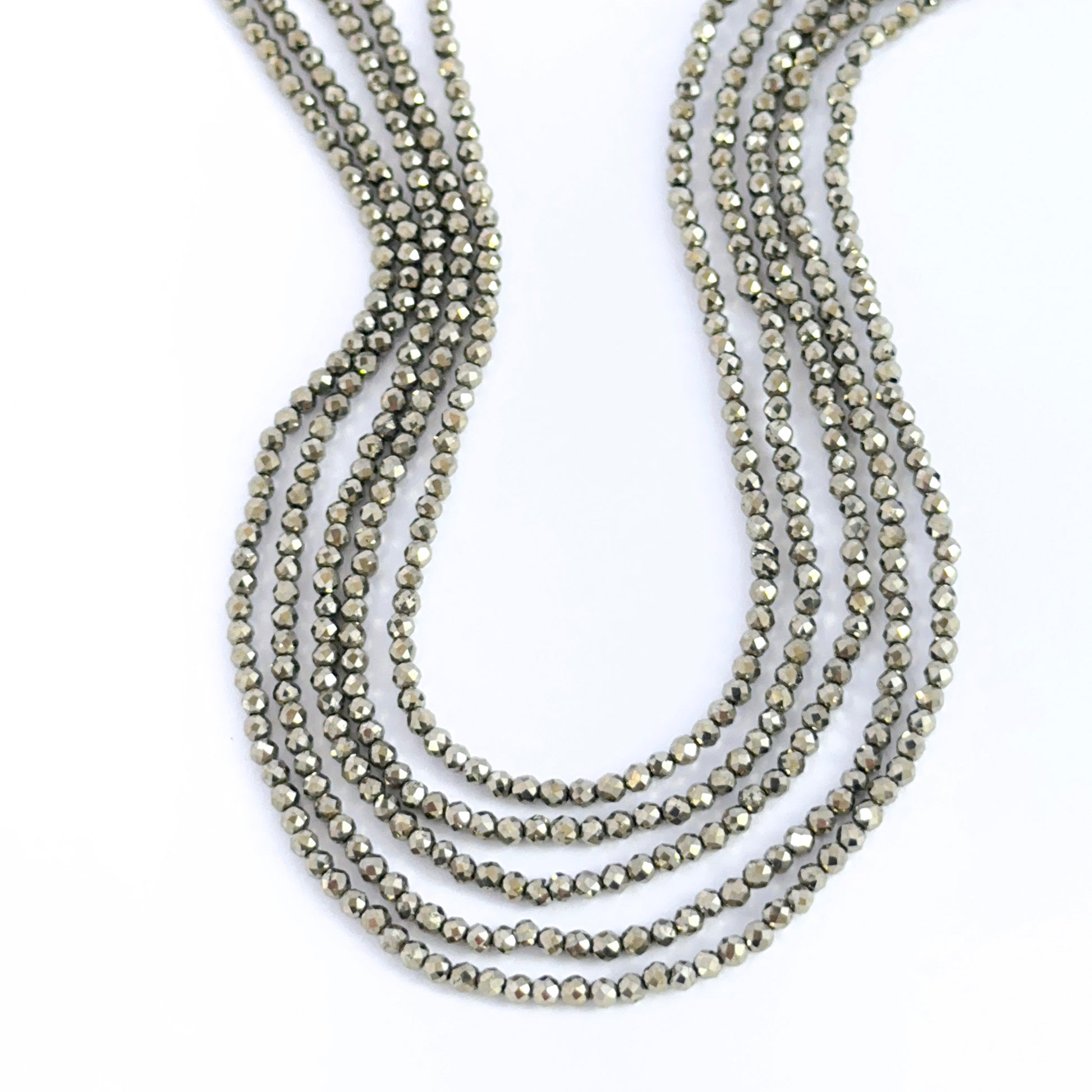 Hand‑selected Pyrite rondelles showing sharp facets and metallic lustre.