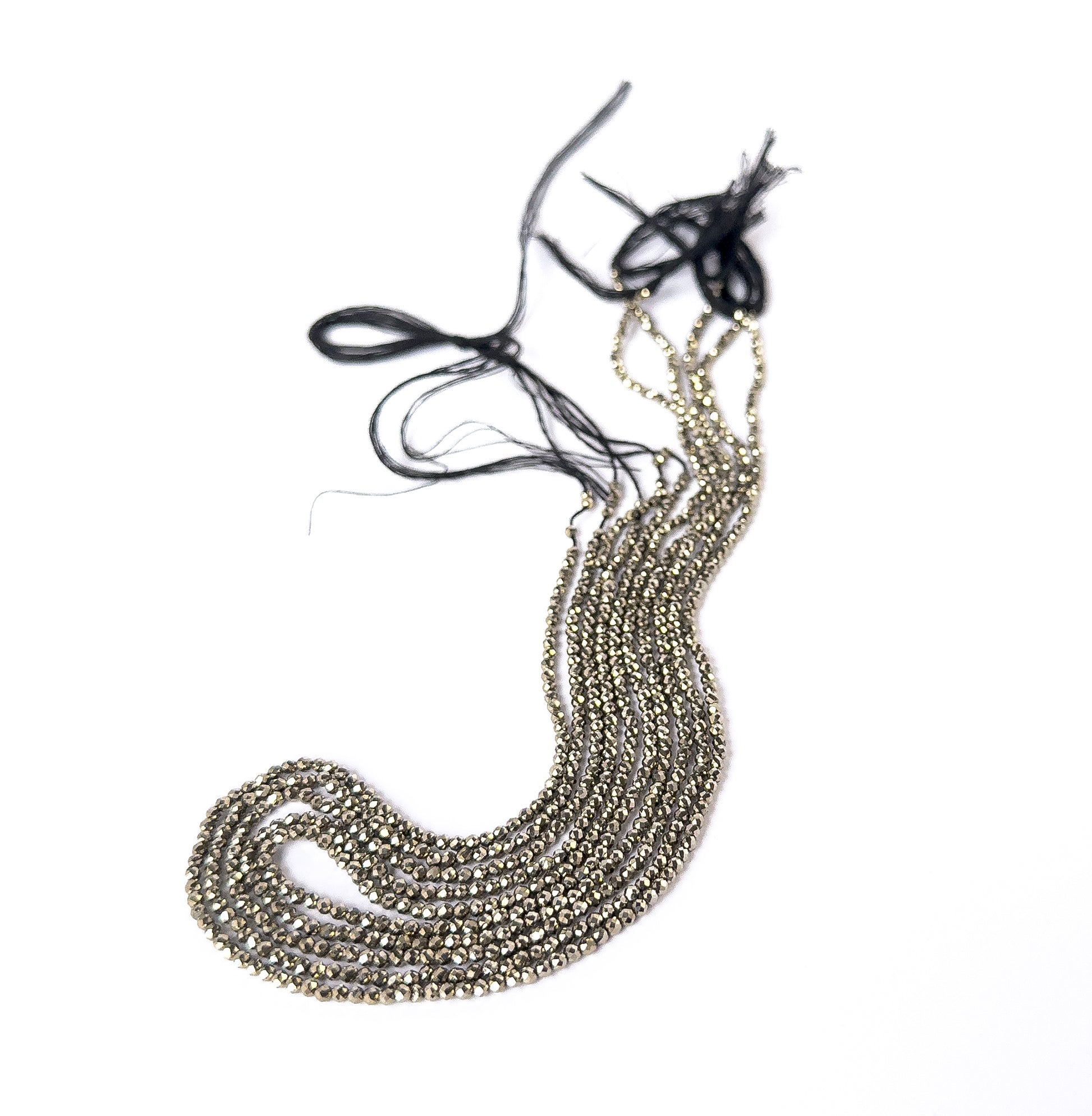 Close‑up of faceted Pyrite rondelles with polished shine, perfect for authentic gemstone bead jewellery.