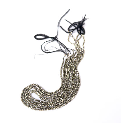 Close‑up of faceted Pyrite rondelles with polished shine, perfect for authentic gemstone bead jewellery.