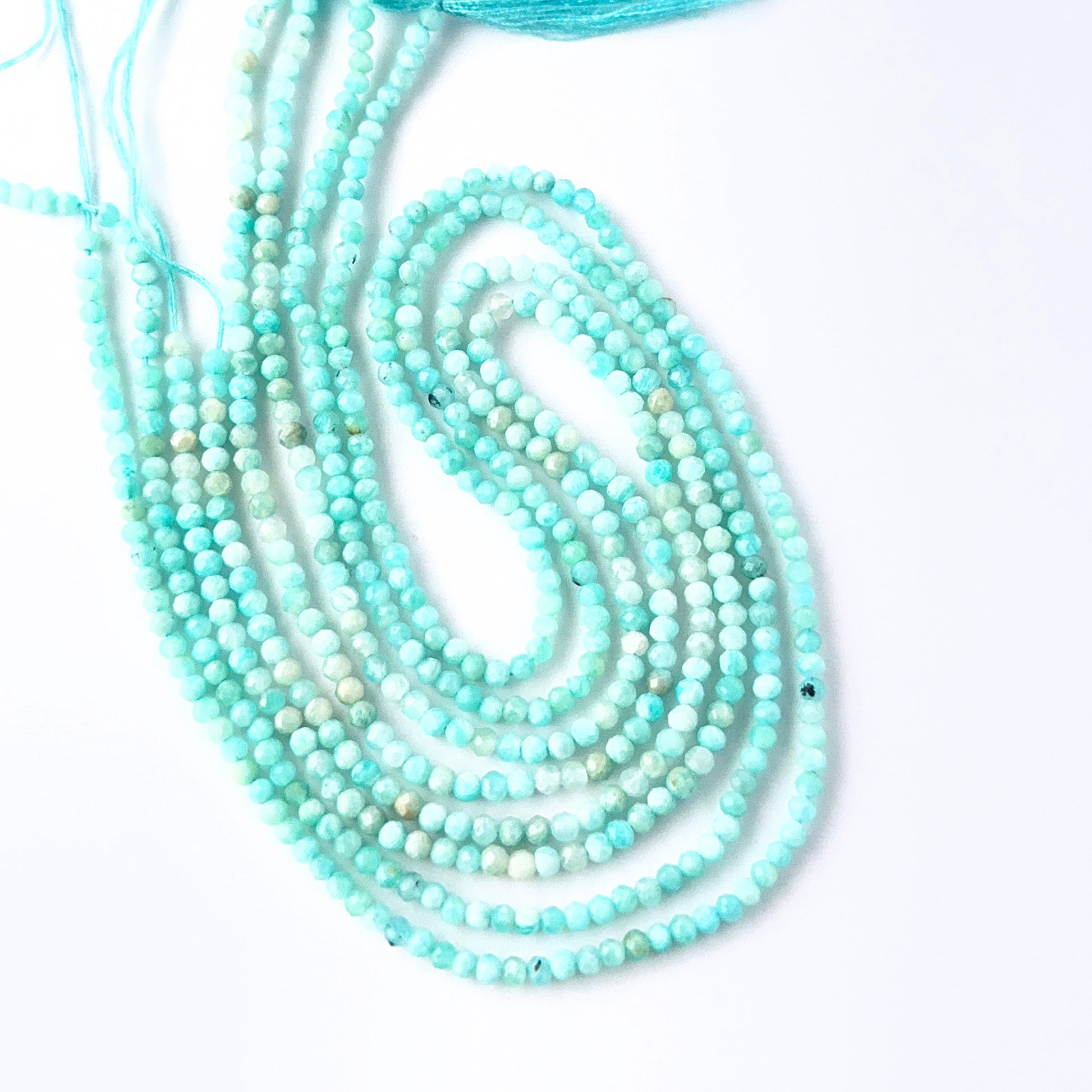 Amazonite rondelle beads with genuine blue‑green colour and reflective faceting for creative jewellery designs