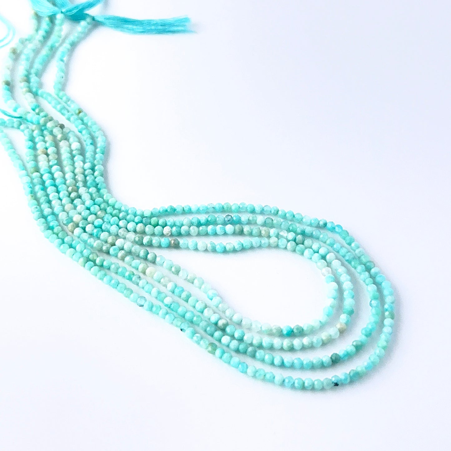Amazonite faceted rondelle beads in a long strand, displaying delicate colour and refined craftsmanship.