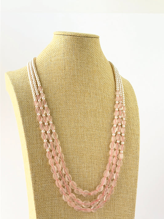 Elegant triple‑strand quartz and shell pearl necklace featuring oval 6–8mm beads arranged in cascading lengths.