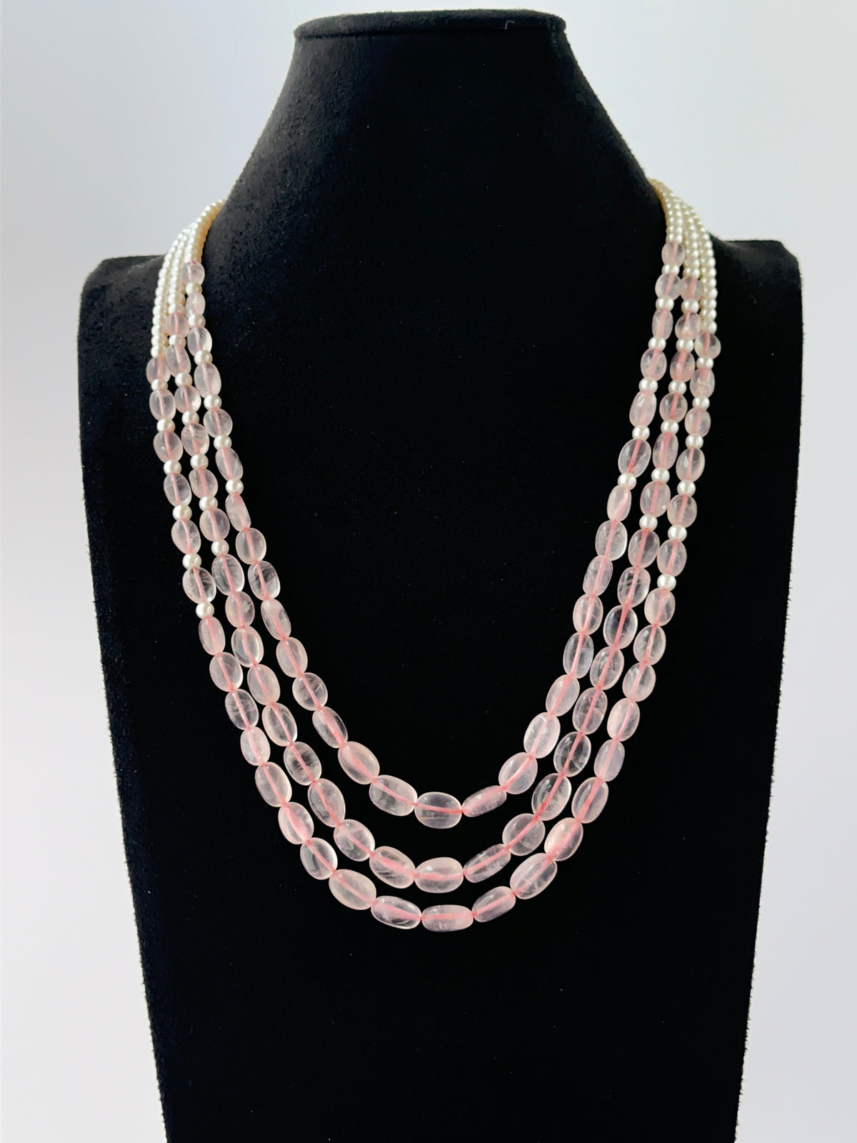Layered three‑strand necklace crafted from oval quartz and shell pearls, 50–55cm long with adjustable fit.