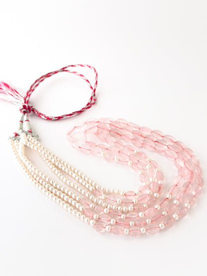 Multi‑strand quartz and shell pearl necklace showcasing smooth oval beads in soft graduated lengths.