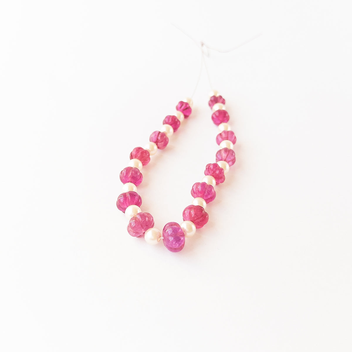 Authentic Quartz and Shell Pearl gemstone beads displaying natural clarity, pearlescent glow, and carved shaping for DIY jewellery makers.