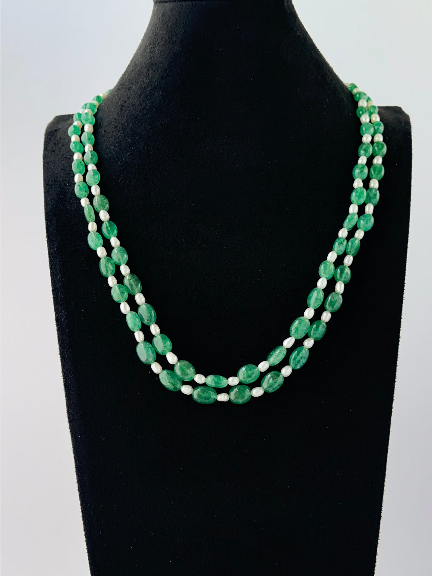 Smooth oval quartz and shell pearl necklace arranged in two strands with adjustable length.