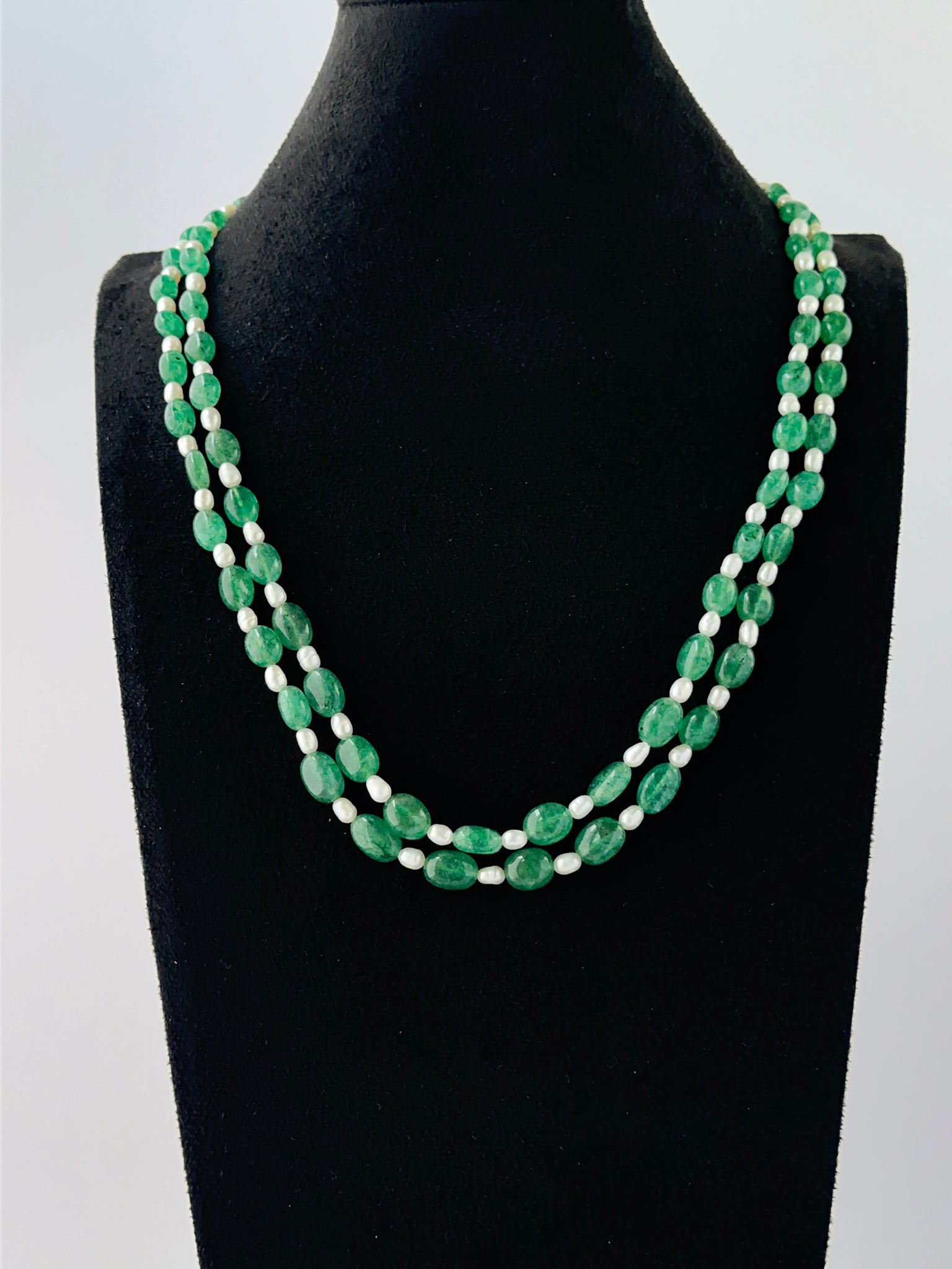 Smooth oval quartz and shell pearl necklace arranged in two strands with adjustable length.