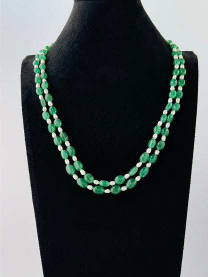 Smooth oval quartz and shell pearl necklace arranged in two strands with adjustable length.