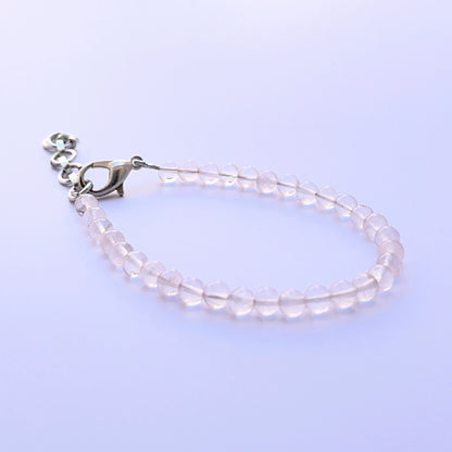 Close‑up of smooth round quartz beads arranged on a finished bracelet.
