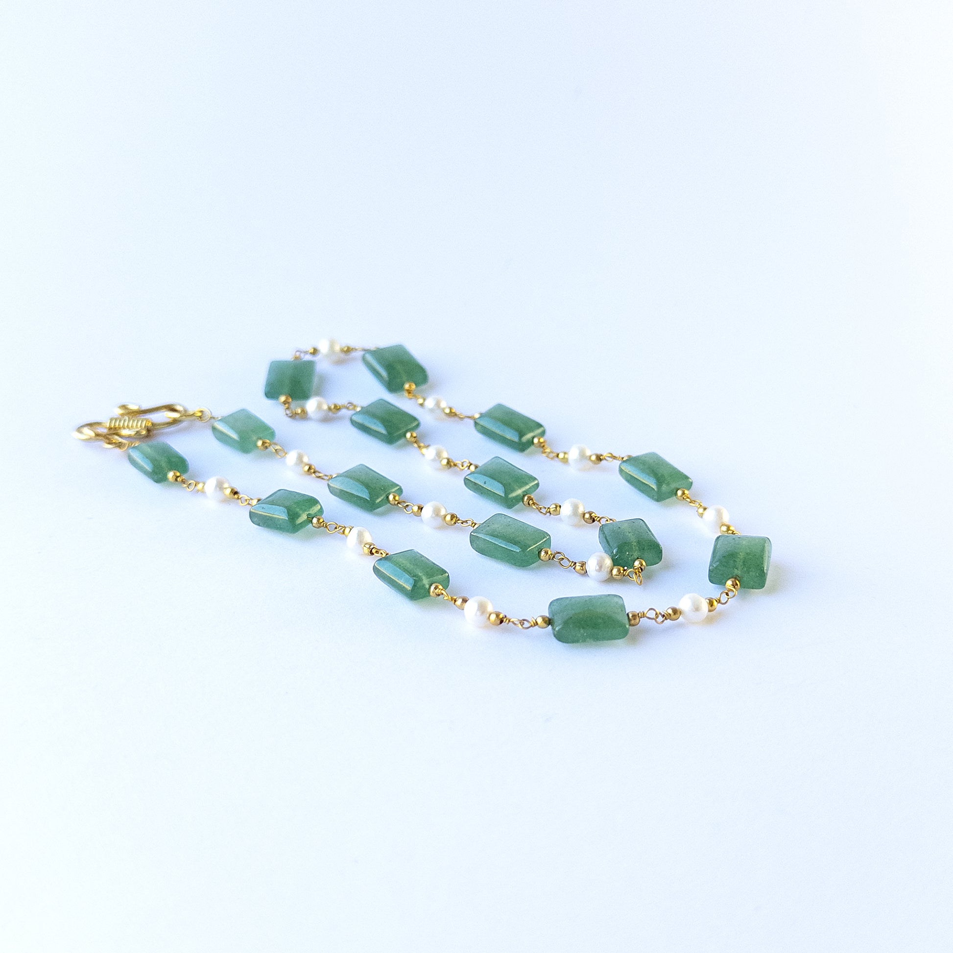 Close up of Quartz and Freshwater Pearl beads showing polished surfaces and elegant soft tones for crafting.