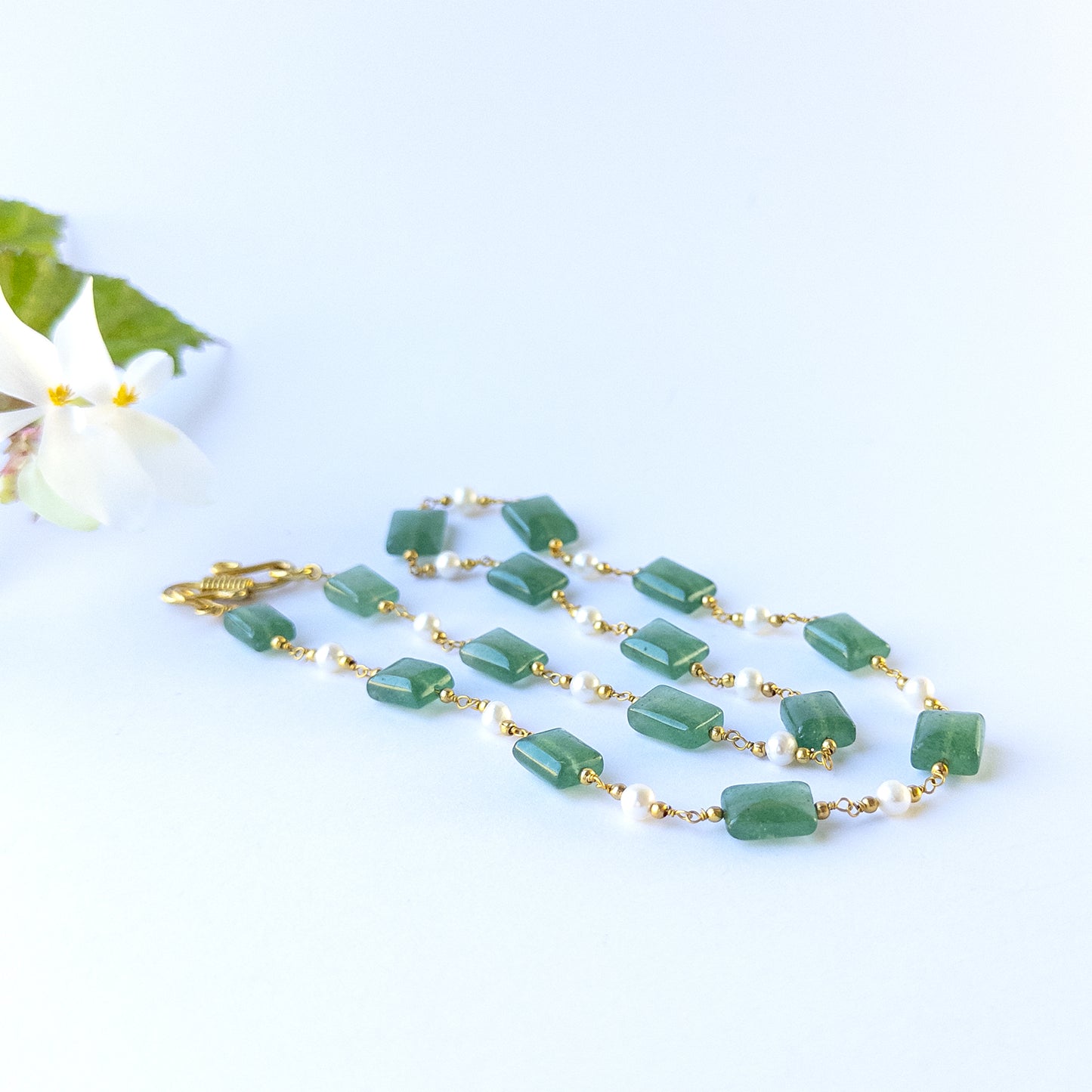 delicate strands of Quartz and Freshwater Pearls beads, showcasing their smooth rectangle design and sparkle