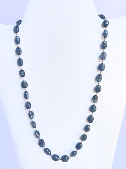 Elegant Quartz necklace, smooth oval beads, 224 carats of brilliance with silk tassel accent.