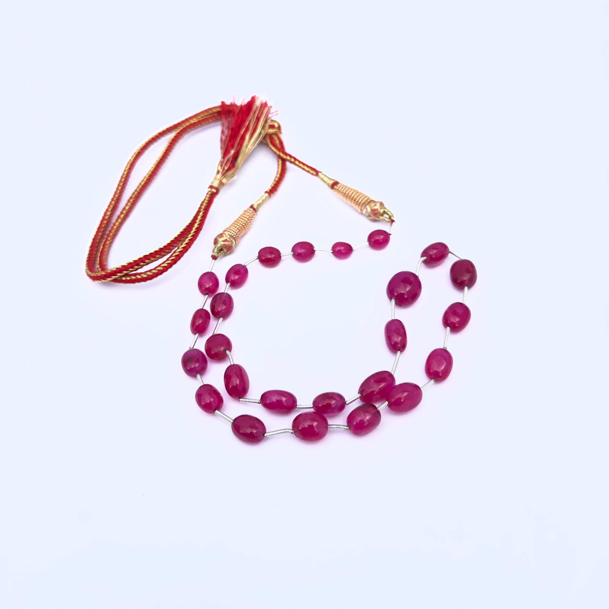 Close-up of polished Quartz gemstone beads showing glossy finish and symmetrical layout.