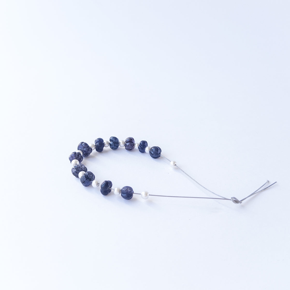 Translucent Quartz pumpkin cut beads arranged neatly, highlighting their carved texture and premium quality.