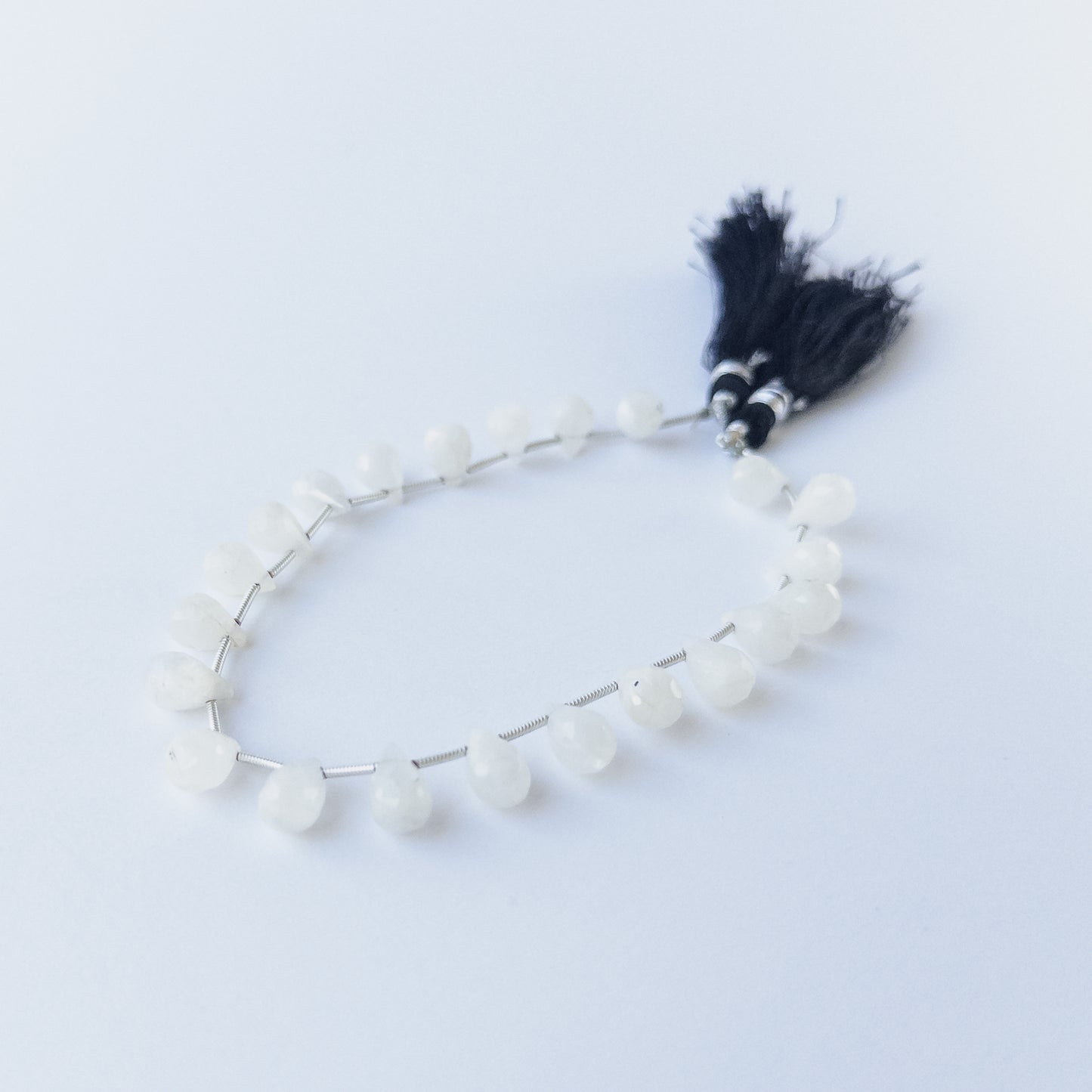 Rainbow Moonstone faceted briolette beads with natural glow, perfect for DIY jewellery makers using gemstone beads.