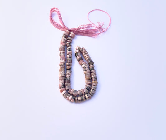 Rhodonite smooth wheel natural gemstone beads in 4.5mm displayed on a 21cm strand.