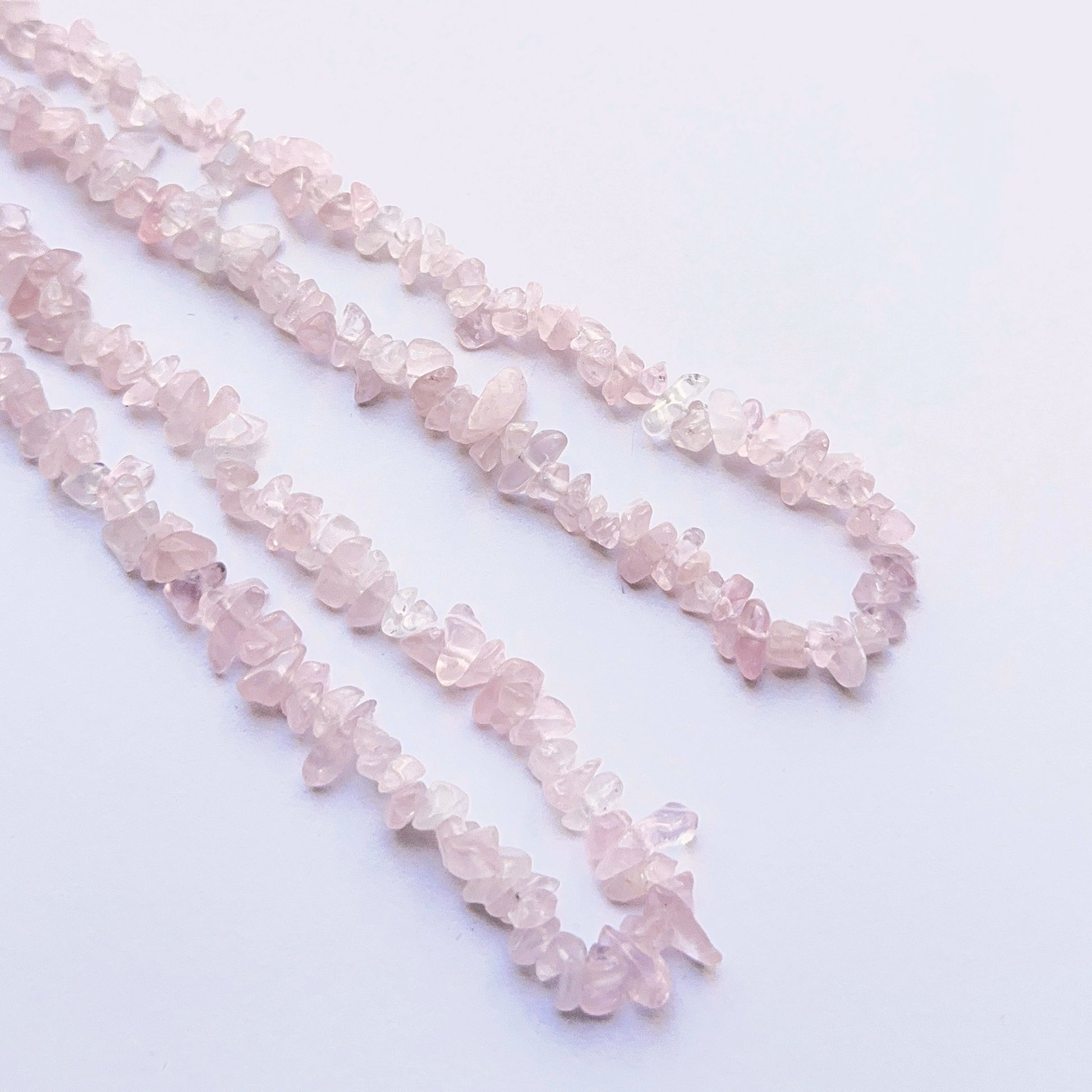 Close-up of natural gemstone beads highlighting the pink hue and handcrafted quality.