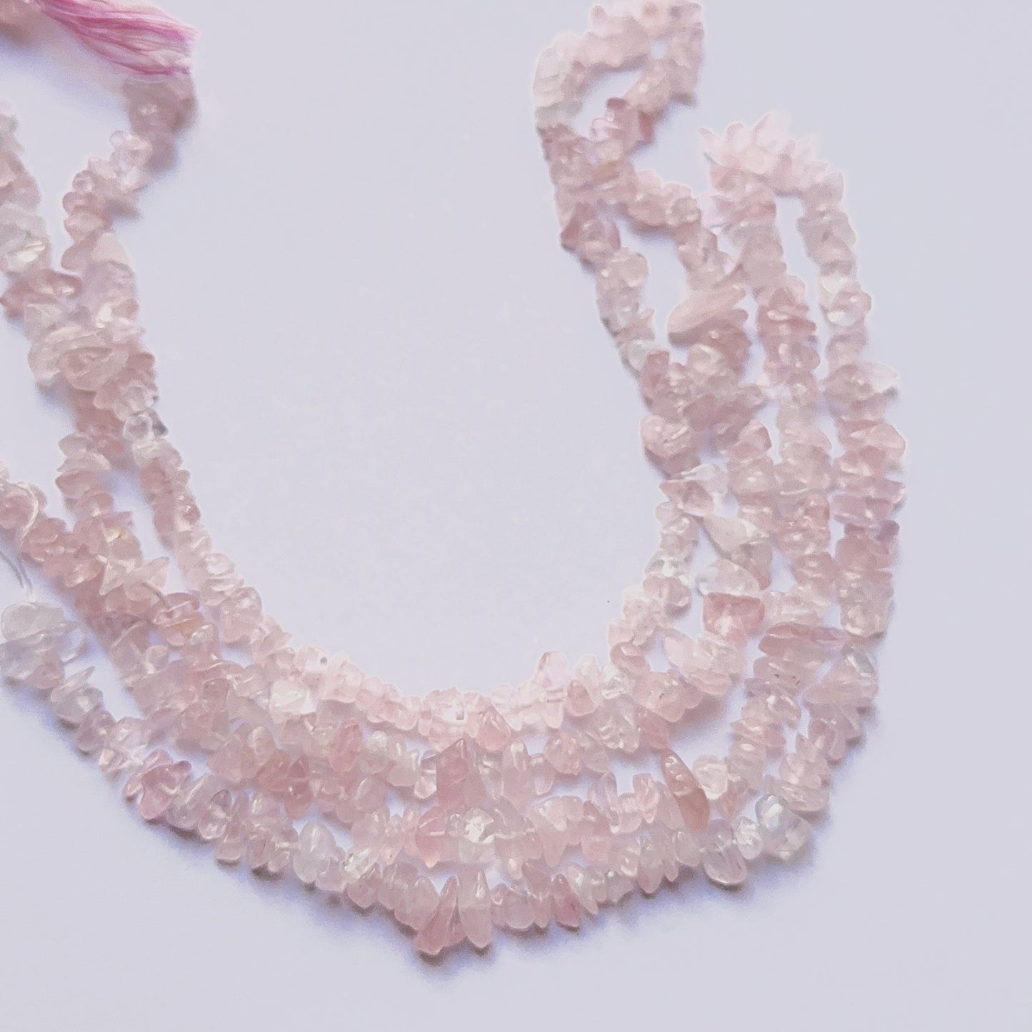 Natural rose quartz chip beads with soft pink tones arranged on a 44cm strand for DIY jewellery. 