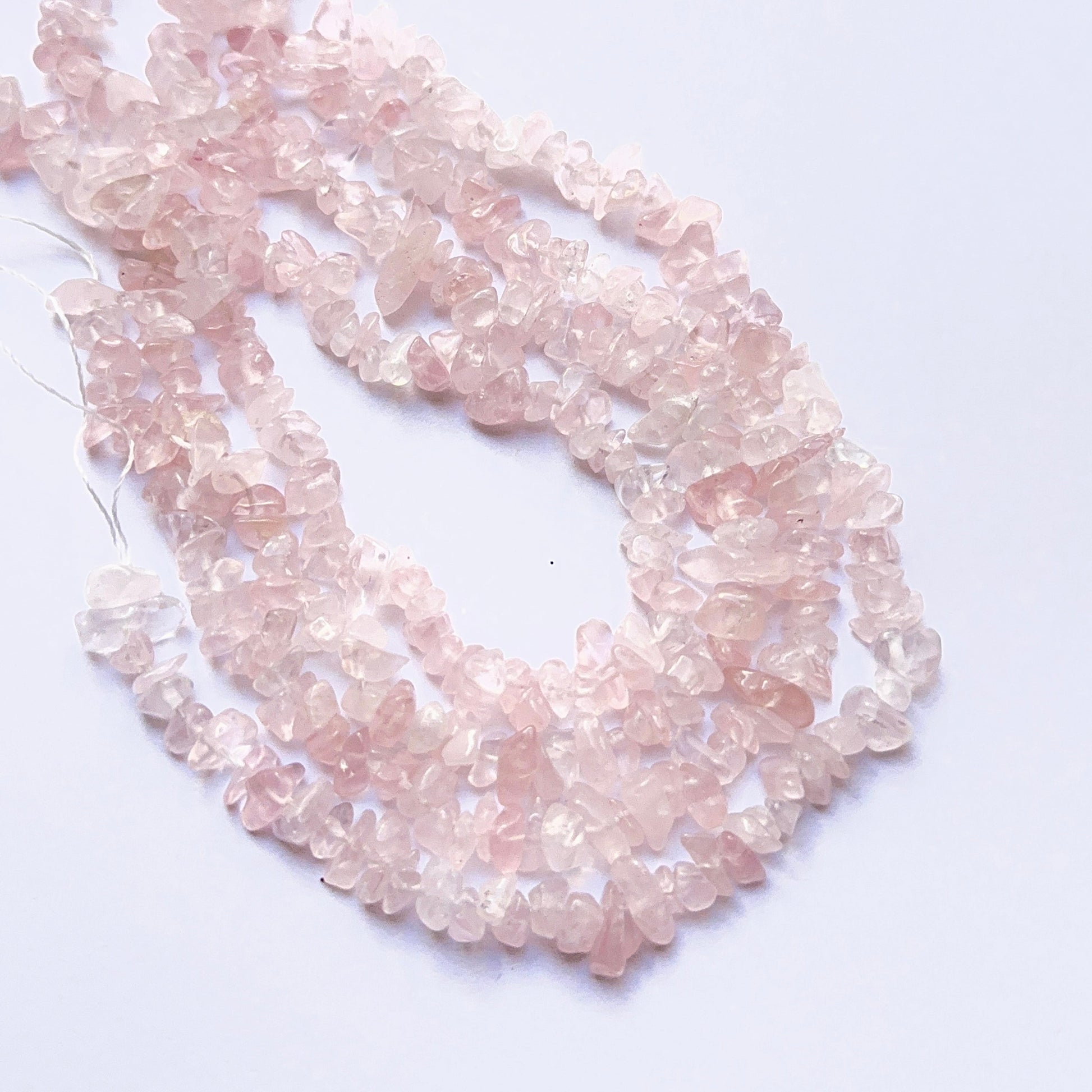 Stone beads in organic rose quartz chips showcasing natural texture and gentle shine.