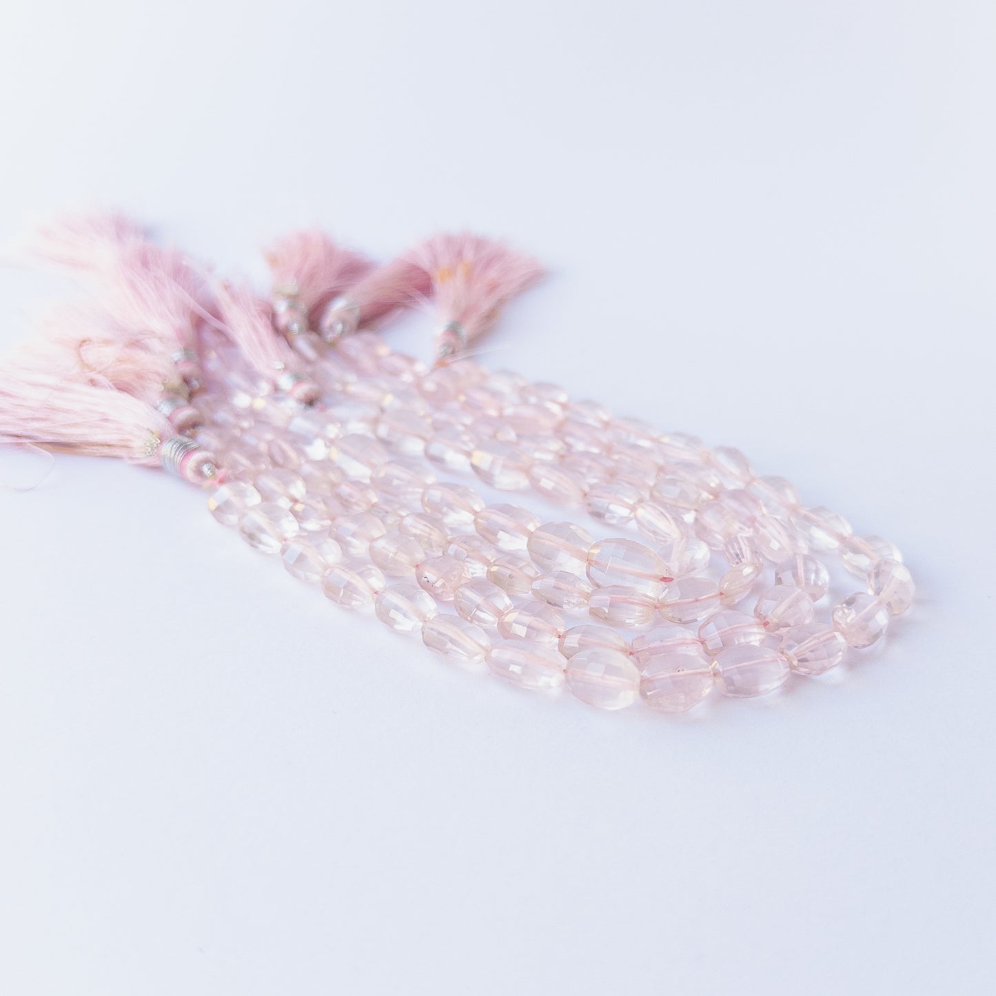 Rose Quartz faceted oval beads displaying gentle translucency and elegant pastel colour.