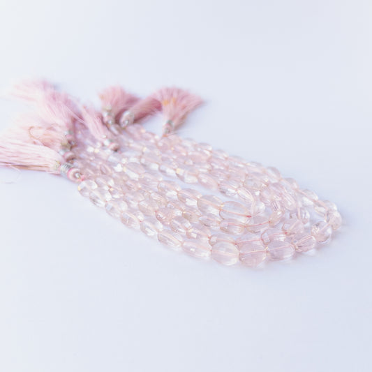 Rose Quartz faceted oval beads displaying gentle translucency and elegant pastel colour.