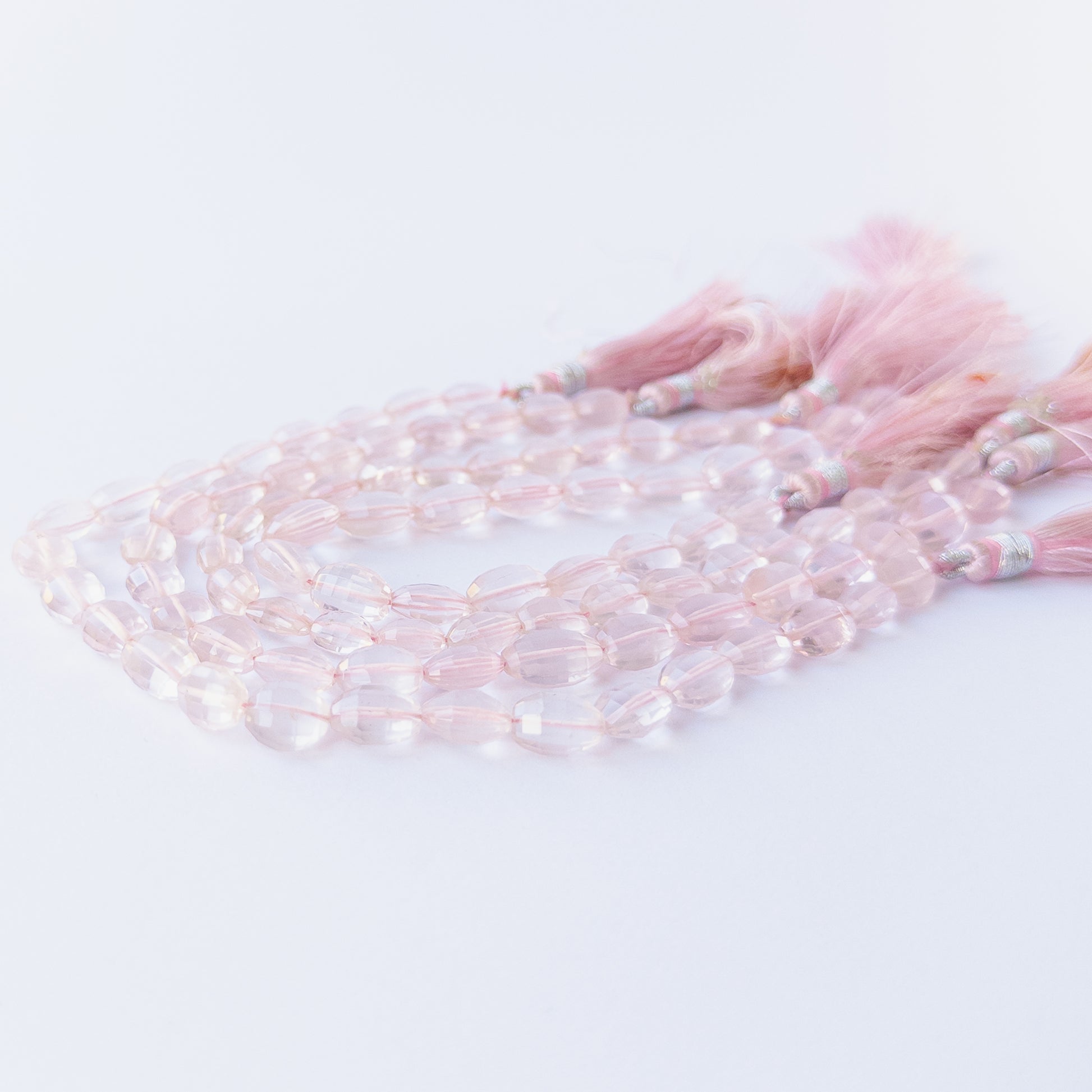 Handmade jewellery components featuring smooth, sparkling Rose Quartz oval gemstone beads.