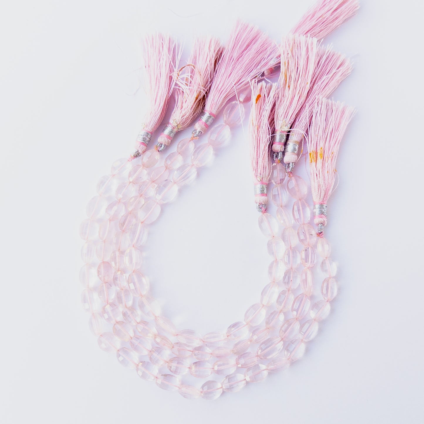 Rose Quartz oval beads showcasing their glossy finish, colour variation and premium craftsmanship