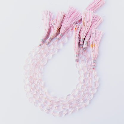 Rose Quartz oval beads showcasing their glossy finish, colour variation and premium craftsmanship