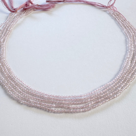 Rose Quartz faceted rondelle beads in 2.2mm size arranged in a 32cm strand with soft pink tones.