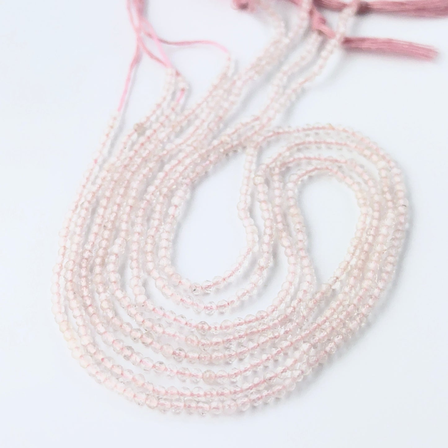 Rose Quartz rondelle beads with genuine pink colour and reflective faceting for creative jewellery designs.
