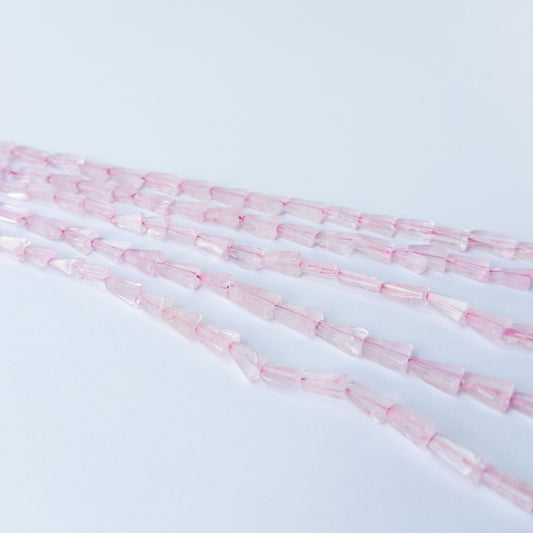 Rose Quartz tapered rectangle gemstone beads arranged on a 32cm strand for handmade jewellery components.