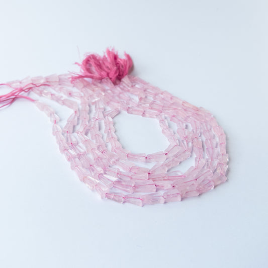Genuine Rose Quartz stone beads in tapered rectangle cut showcasing soft pink colour and smooth polish.