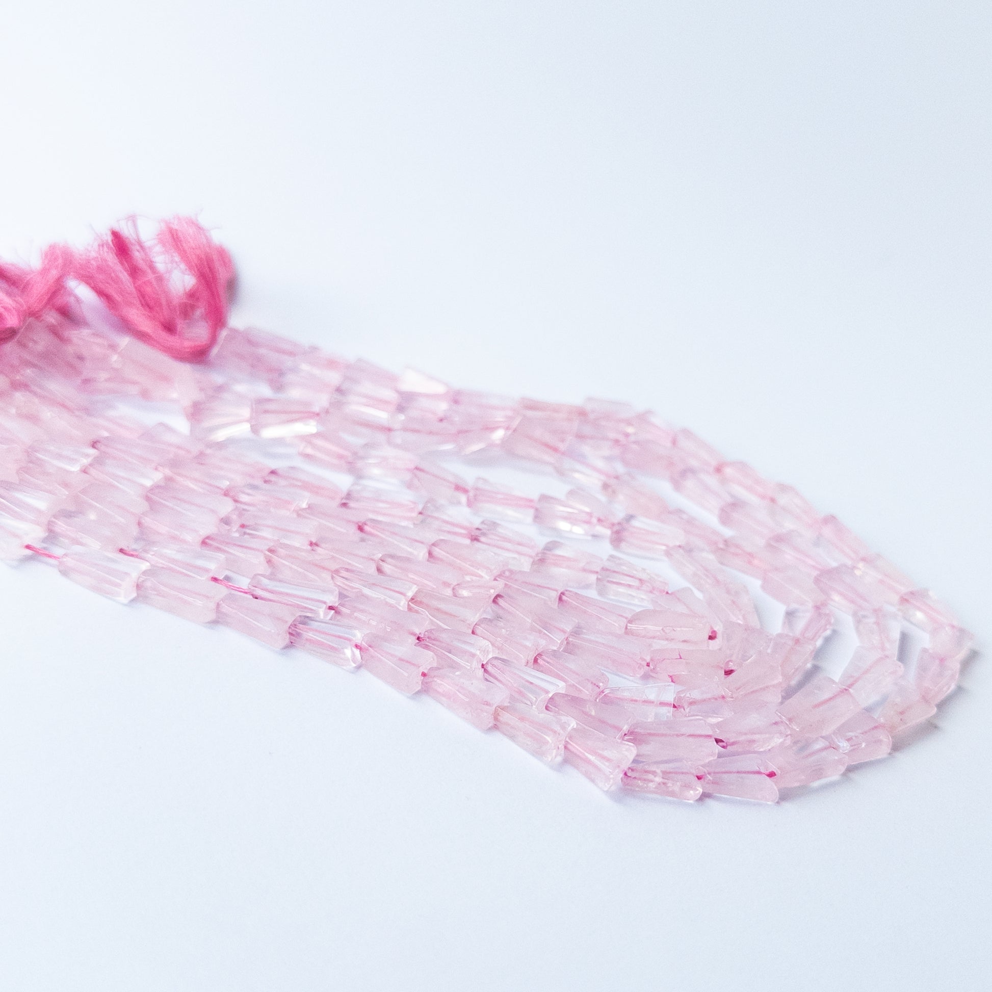 Handmade jewellery components featuring Rose Quartz tapered rectangle beads with soft feminine hues.
