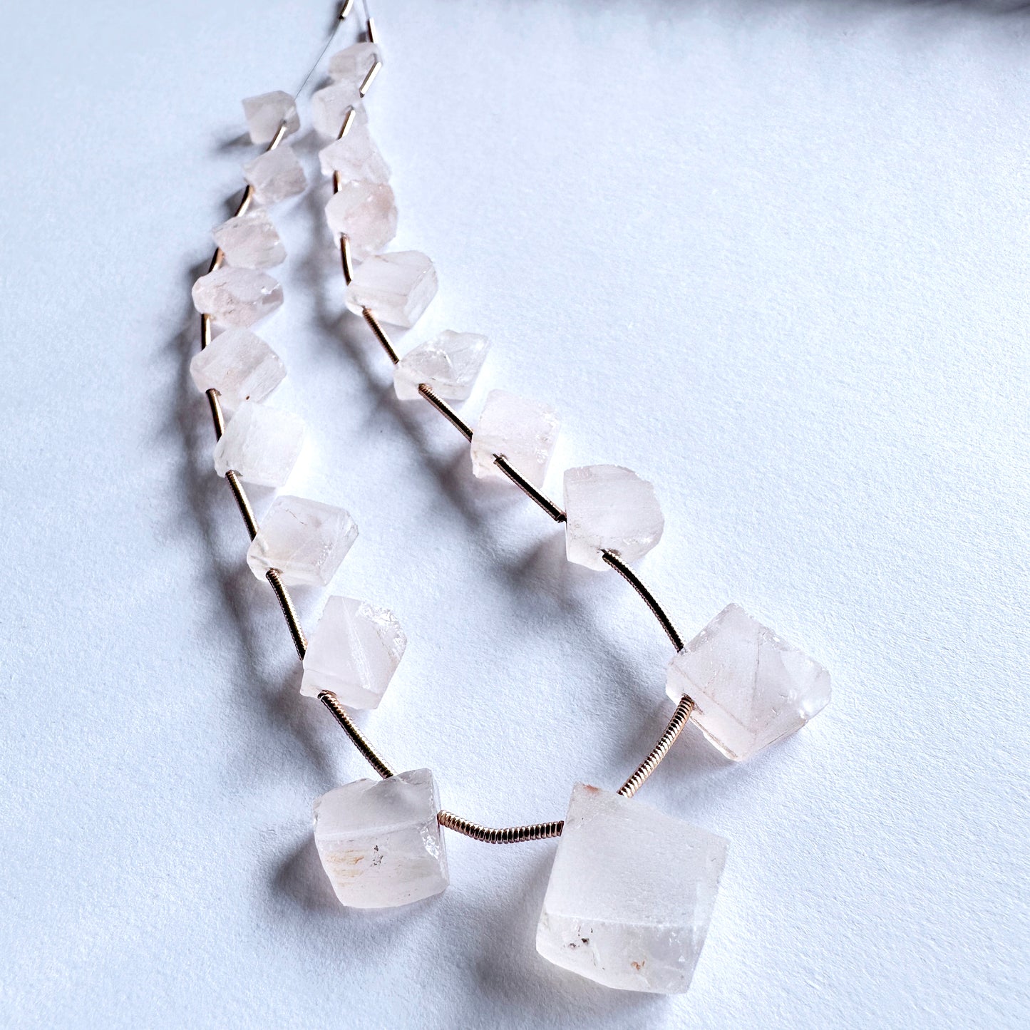 Natural Rose Quartz beads in soft blush tones, drilled on the rough side for unique jewellery designs.