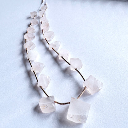Natural Rose Quartz beads in soft blush tones, drilled on the rough side for unique jewellery designs.