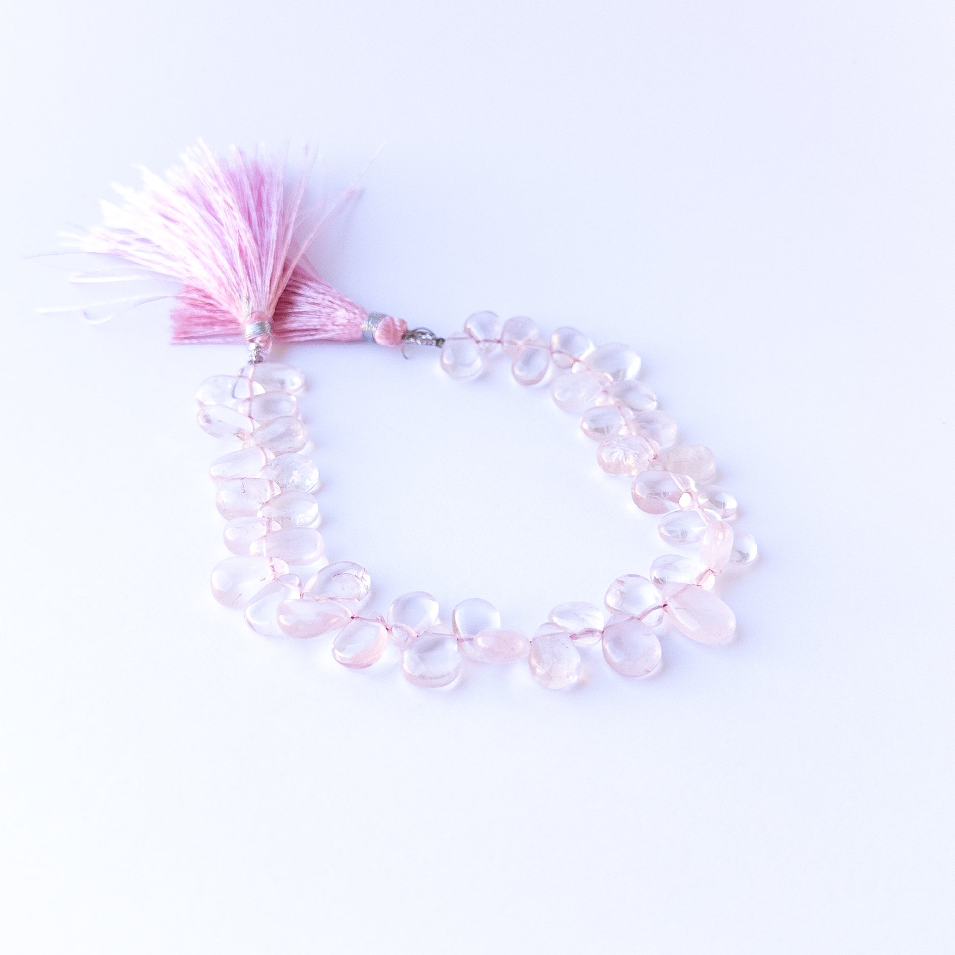 Genuine stone beads in soft pink hues, featuring smooth briolettes for DIY jewellery making.